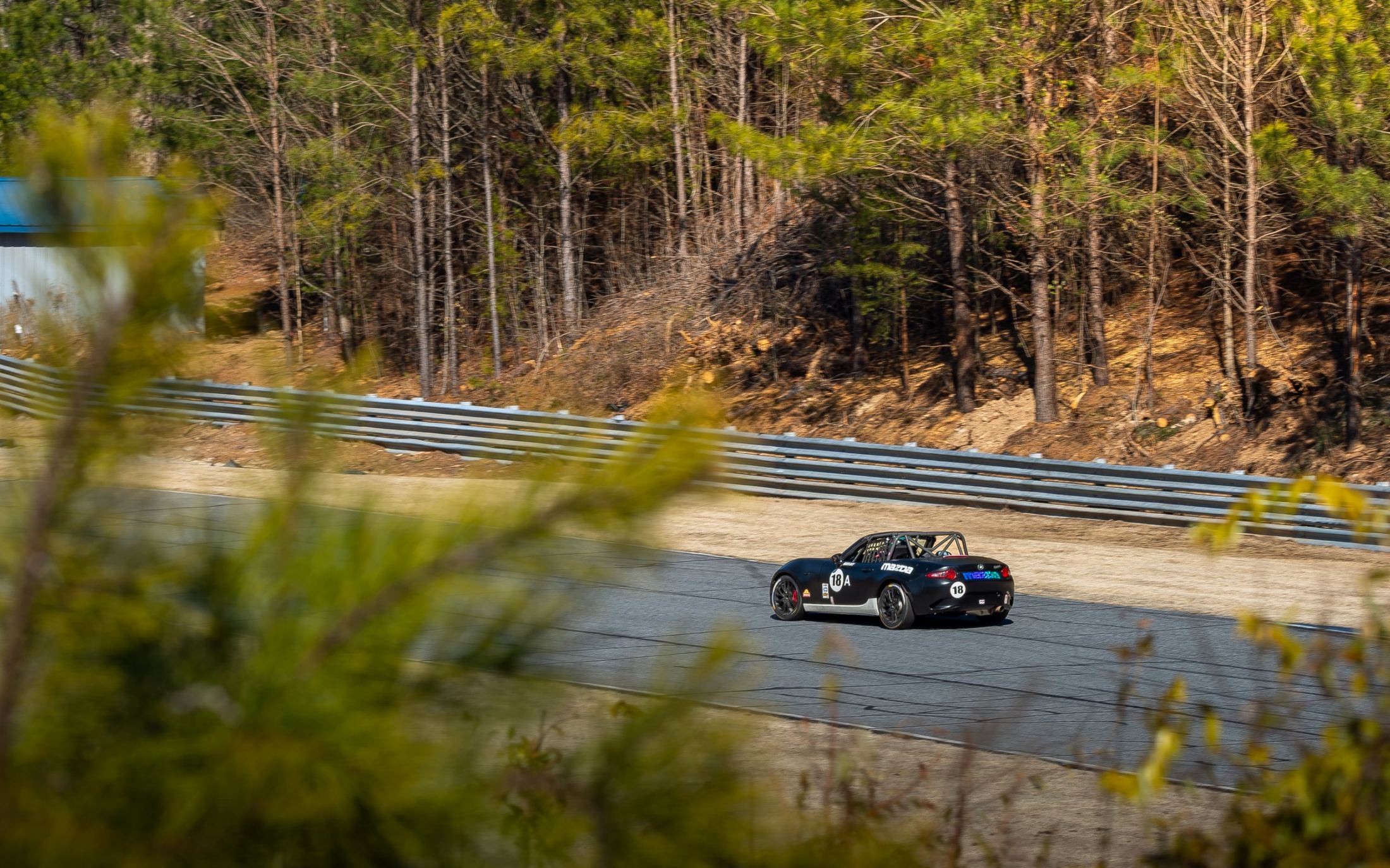 Black #18 MX-5 Cup car on track